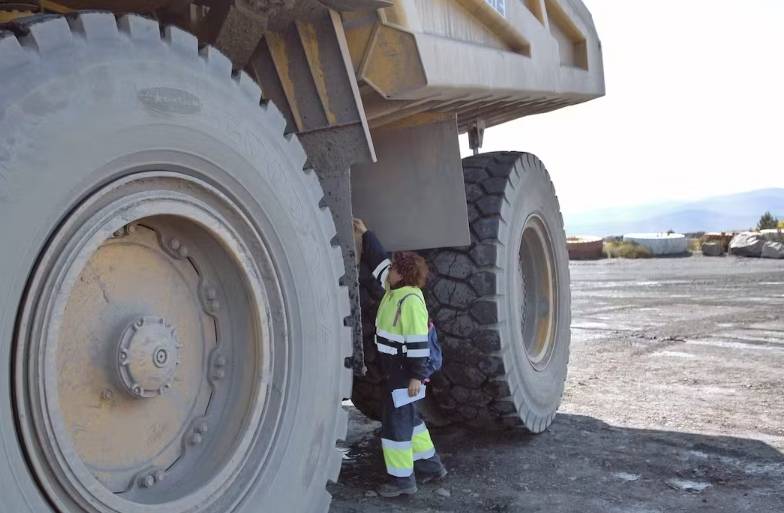 Cristina Carro inspect on the side of the quarry truck